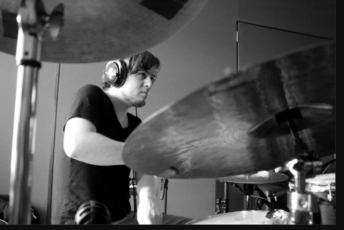 Black and white studio portrait of drummer Christian Tschuggnall, Berlin Sessions
